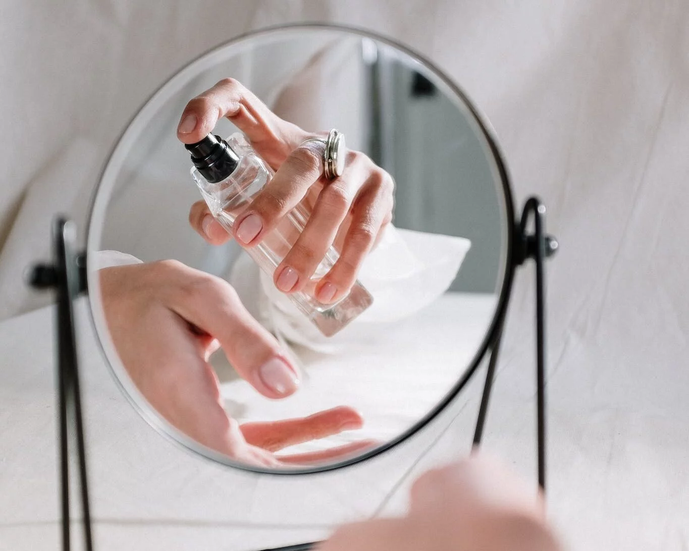 Person Holding Clear Glass Round Mirror