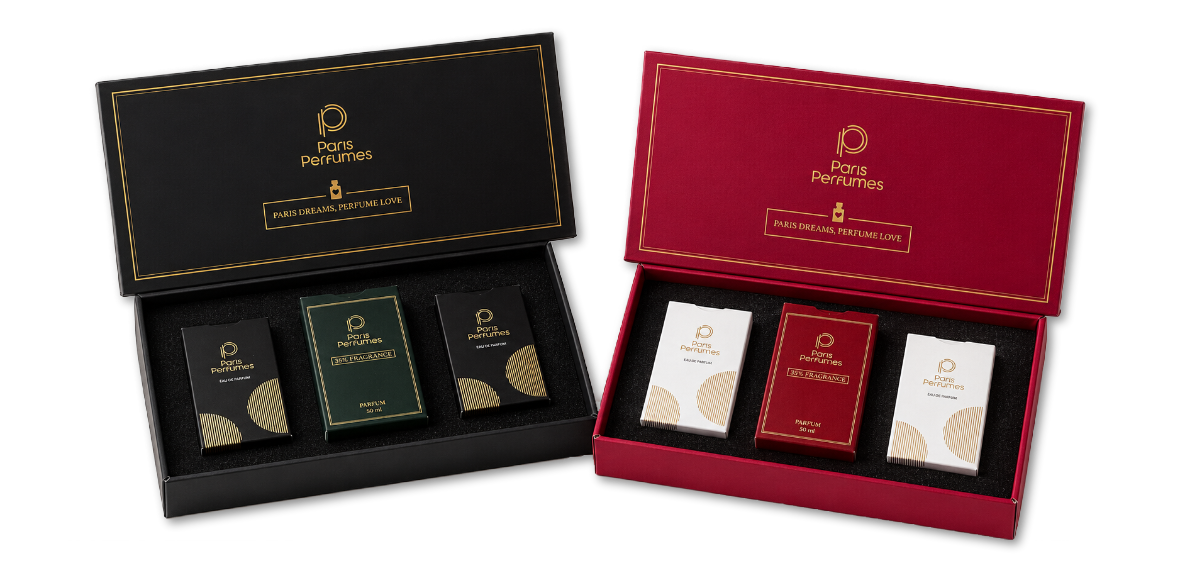 Két nyitott Paris Perfumes ajándékdoboz, egy fekete és egy bordó, mindegyikben három flakonnal